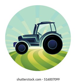 Agricultural tractor in a plowing field at sunrise