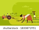 Agricultural workers planting paddy seedlings in the field with a tractor in the background