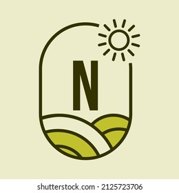 Agriculture Logo On Letter N Emblem Template. Farmland Letter N Agro Farm, Agribusiness, Eco-farm Sign with Sun and Agricultural Field Symbol