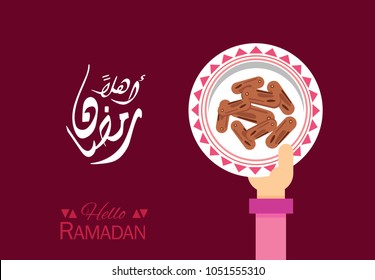 "Ahlan Ramadan" Hello Ramadan month ..Hand holding a plate of dates..greeting card