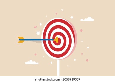 Aiming for children education target, parenting or kid knowledge or skill, humor business target or achievement concept, bow arrow children toy with suction cup hit sweet lollipop bullseye target.