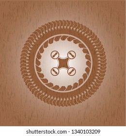 air drone icon inside badge with wooden background