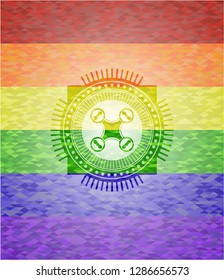 air drone icon inside emblem on mosaic background with the colors of the LGBT flag