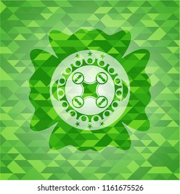 air drone icon inside green emblem with mosaic ecological style background