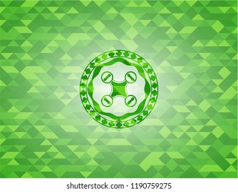 air drone icon inside green emblem with mosaic background