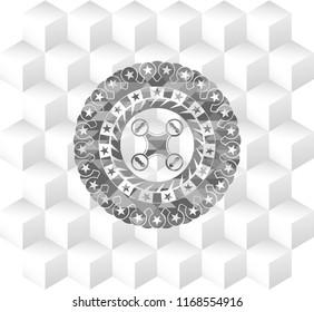 air drone icon inside grey emblem with geometric cube white background