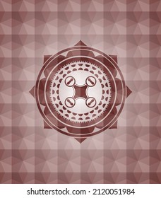 air drone icon inside red seamless badge with geometric pattern. 