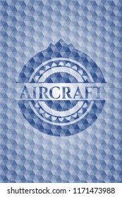 Aircraft blue emblem with geometric pattern background.