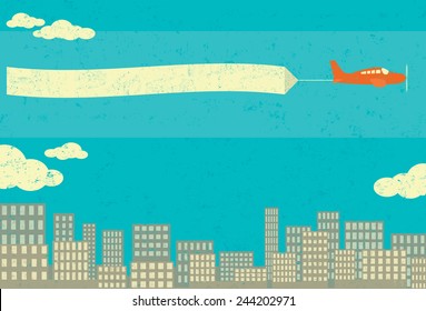 Airplane Advertising An airplane with blank advertising banner over a city skyline in the background. The airplane and the background are on separate labeled layers.