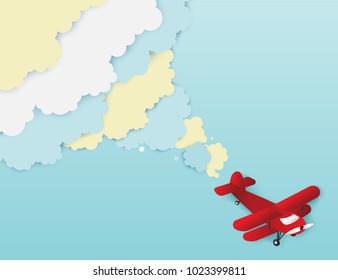 Airplane aerial view paper art with paper cloud ( speech bubble ) for text. Flying origami paper art red plane. Blue sky background with fluffy clouds
