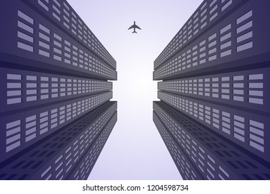 the airplane flying in the sky visible between the skyscrapers