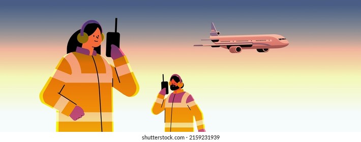 airport workers marshallers communicating over walkie-talkie with air traffic control while airplane flying in sky professional airport staff