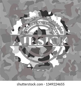 Airsick written on a grey camouflage texture