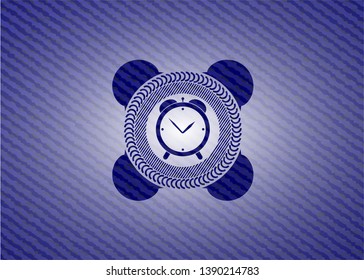 alarm clock icon inside badge with denim texture