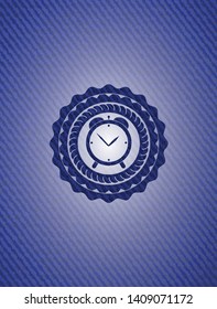alarm clock icon inside badge with denim texture
