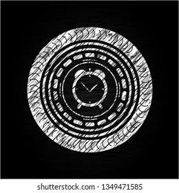 alarm clock icon inside chalkboard emblem written on a blackboard
