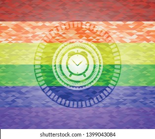 alarm clock icon inside emblem on mosaic background with the colors of the LGBT flag