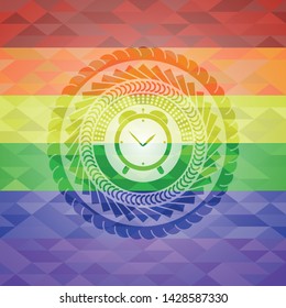 alarm clock icon inside emblem on mosaic background with the colors of the LGBT flag