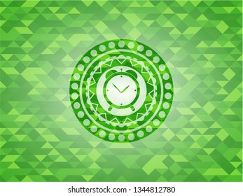 alarm clock icon inside green mosaic emblem
