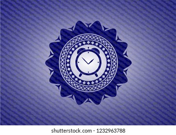 alarm clock icon inside jean or denim emblem or badge background