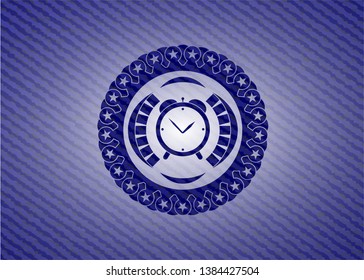 alarm clock icon inside jean or denim emblem or badge background