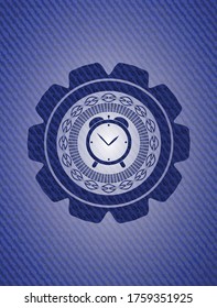 alarm clock icon inside jean background. 