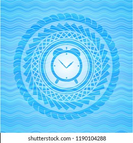 alarm clock icon inside light blue water wave badge.
