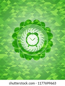 alarm clock icon inside realistic green emblem. Mosaic background