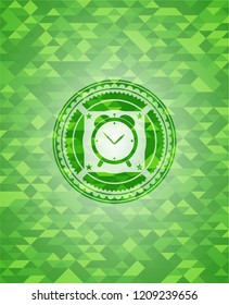 alarm clock icon inside realistic green emblem. Mosaic background