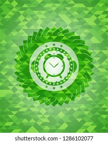 alarm clock icon inside realistic green emblem. Mosaic background
