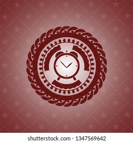 alarm clock icon inside red emblem
