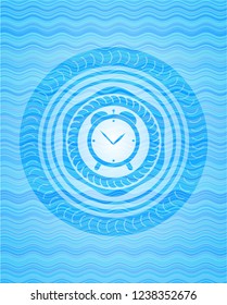 alarm clock icon inside sky blue water wave badge background.
