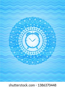alarm clock icon inside sky blue water badge.