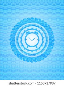 alarm clock icon inside water badge background.