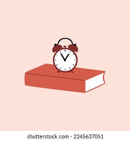 Alarm clock on the book. Reading time concept.Time to study, enjoying good book, learning