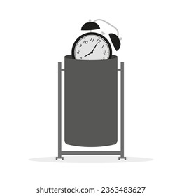 Alarm clock in trash can on white background