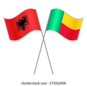 Albanian and Beninese crossed flags. Albania combined with Benin isolated on white. Language learning, international business or travel concept.