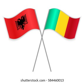 Albanian and Guinean crossed flags. Albania combined with Guinea isolated on white. Language learning, international business or travel concept.