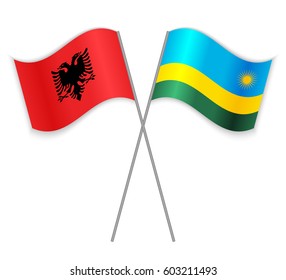 Albanian and Rwandan crossed flags. Albania combined with Rwanda isolated on white. Language learning, international business or travel concept.