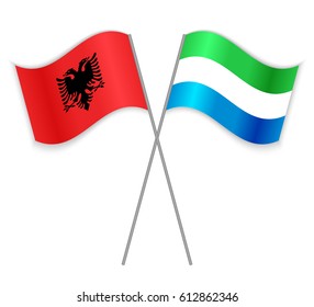 Albanian and Sierra Leonean crossed flags. Albania combined with Sierra Leone isolated on white. Language learning, international business or travel concept.