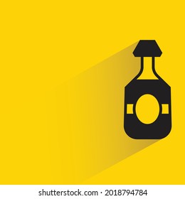 alcohol bottle with shadow on yellow background
