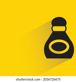 alcohol bottle with shadow on yellow background