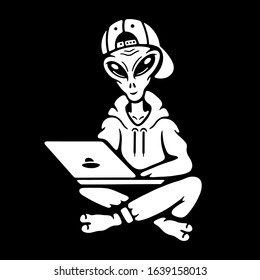 Alien in the cap laptop on black background
