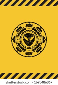 alien icon black grunge emblem, yellow warning sign. Vector Illustration. Detailed.