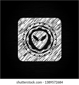 alien icon drawn on a blackboard