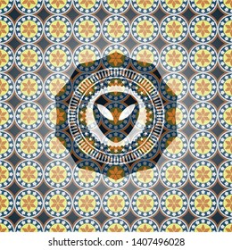 alien icon inside arabesque badge background. arabic decoration.