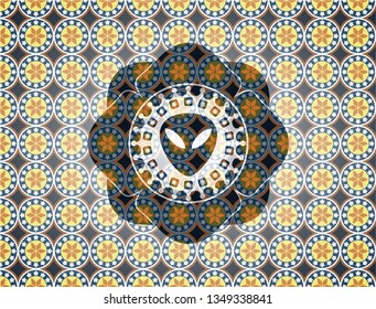 alien icon inside arabesque style badge. arabic decoration.