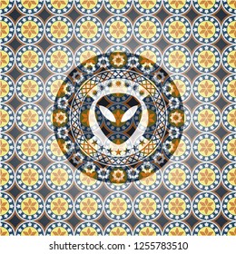 alien icon inside arabic badge. Arabesque decoration.
