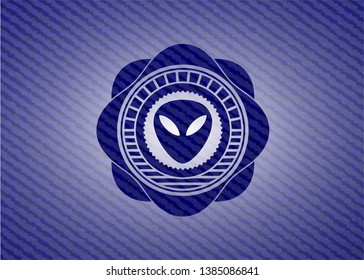 alien icon inside badge with denim texture