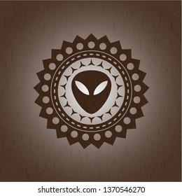alien icon inside badge with wooden background